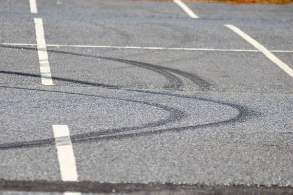 tire shadows on asphalt road