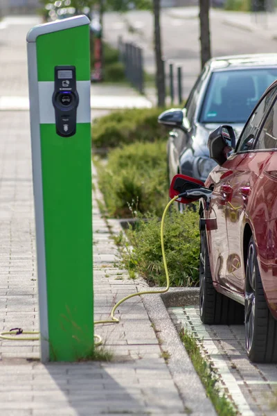 Electric cars charging at public charging station with renewable energy for electric vehicles and eco friendly zero CO2 emissions and green energy follows the government scheme for battery powered car
