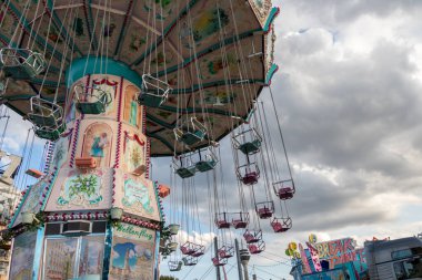 Dsseldorf, NRW, Germany - 07 14 2022: chairoplane and chain carousel waiting for guests on the Dusseldorfer Rheinkirmes amusement park as big parish fair and kermis in Germany for fun and whirligig