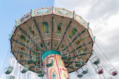 Dsseldorf, NRW, Germany - 07 14 2022: chairoplane and chain carousel waiting for guests on the Dusseldorfer Rheinkirmes amusement park as big parish fair and kermis in Germany for fun and whirligig