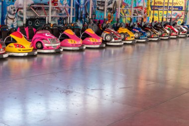 Dusseldorf, NRW, Germany - 07 14 2022: bumper cars and dodgem cars waiting for drivers on the Dusseldorfer Rheinkirmes amusement park as big parish fair and kermis in Germany for fun and action cars