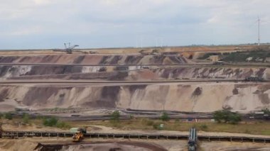 Neuss, Germany - 07 31 2022: Garzweiler brown coal and open pit mine for ignite shows natural disaster of surface mining and exploitation of fossil energy with heavy machinery like excavators diggers