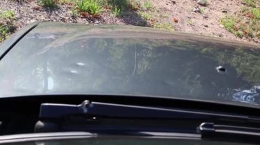 Damaged car engine hood with many hail damage dents show the importance of car insurance and a replacement value insurance against stormy weather storm hazards or extreme weather hail storms blizzards
