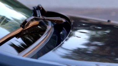 Damaged car engine hood with many hail damage dents show the importance of car insurance and a replacement value insurance against stormy weather storm hazards or extreme weather hail storms blizzards