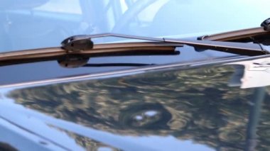 Damaged car engine hood with many hail damage dents show the importance of car insurance and a replacement value insurance against stormy weather storm hazards or extreme weather hail storms blizzards