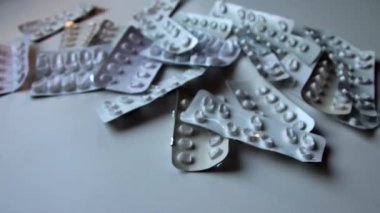 Many empty pill packages blisters of drug addicted people and drug abusing people as pharmaceutical painkiller and medical therapy overdose treatment for medical addicted people and dangerous overdose