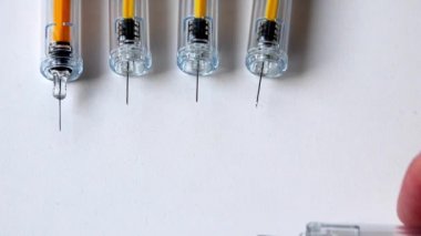 Multiple injection syringes show vaccinations doses and booster vaccination dose for covid-19 vaccine prevention and medical treatment with liquid drugs for pharmaceutical wealth with 3rd mrna vaccine