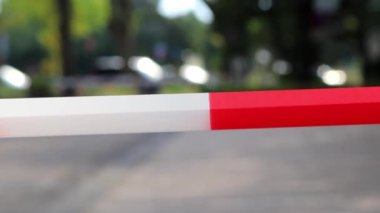 Red white barrier tape in pandemic lockdown marks crime scene restricted area as margin of safety to prohibit no trespassing in dangerous emergency and protection boundary for quarantine security stop