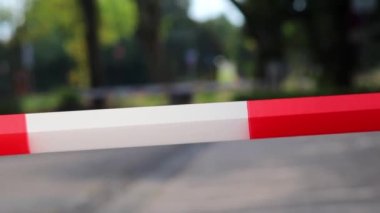 Red white barrier tape in pandemic lockdown marks crime scene restricted area as margin of safety to prohibit no trespassing in dangerous emergency and protection boundary for quarantine security stop