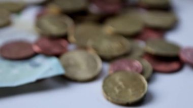 Euro money savings sliding inside glass jar full of Euro coins and Euro banknotes for financial management of pocket money and tip or gratuity for piggy bank currency pile as cash close-up macro view