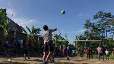 Asian slow mo video serving ball in volleyball