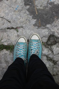 photo of light blue shoes worn combined with black pants
