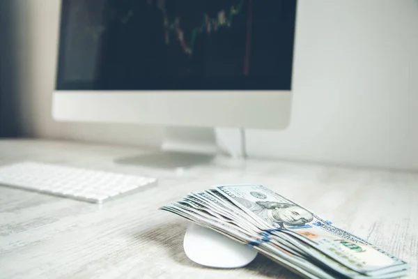 money with computer on the wooden desk