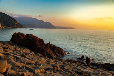 Kayalıkları ve günbatımı olan güzel deniz