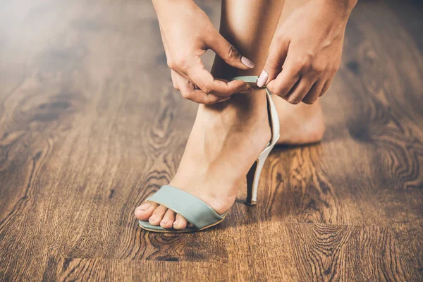 Женщина Примеряет Обувь Деревянном Фоне — стоковое фото