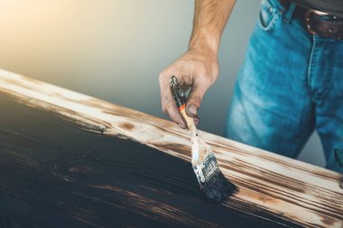 Erkek eli siyah boya ve ahşap fırça