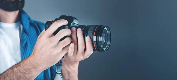 photographer hand camera on gray background