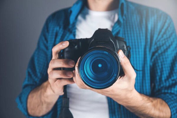 photographer hand camera on gray background