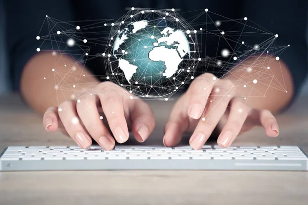 woman hand keyboard with globe network in screen