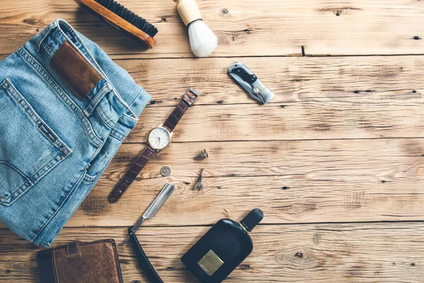 men accessories with jeans and perfume on desk