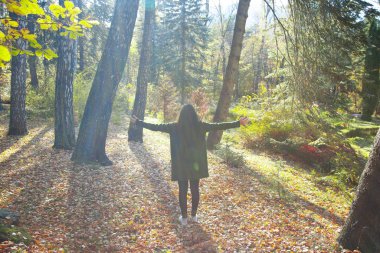 happy woman in colorful autumn forest