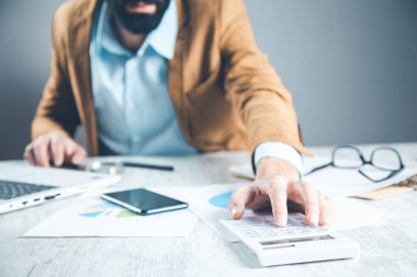 man hand calculator with document on desk
