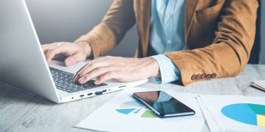 man working in computer on desk