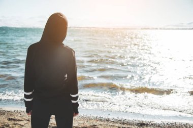 woman in back in lake background