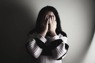 young sad woman hand in the face