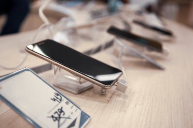 different smart phones in store background