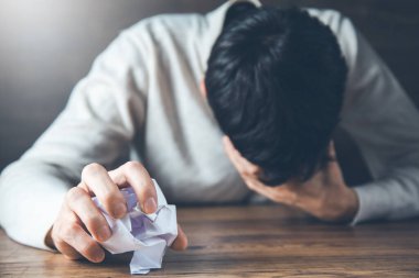 sad man hand crumpled paper 