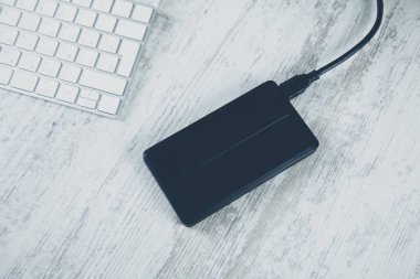 black HDD on the wooden desk background