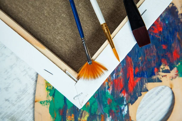 Paint brushes and paints for drawing on desk