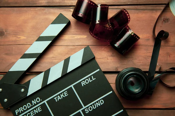 Movie Clapper Filmstrip Lenses Wooden Background — Stock Photo, Image