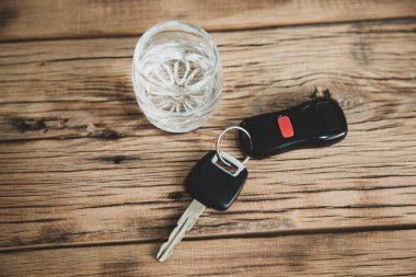 Masasında bir bardak votka olan araba anahtarı.