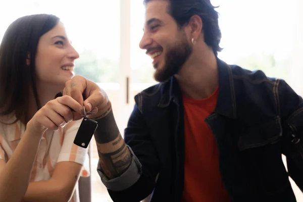 Rental contract. Transport purchase. Happy Couple with car key. Happy young couple chooses and buying a new car for the family.