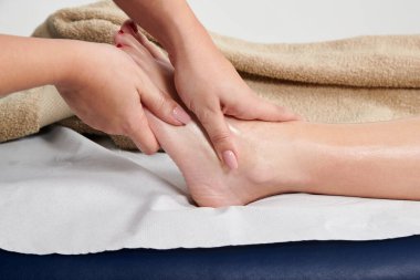 Profesyonel bir masöz bayan müşterisine masaj yapıyor.