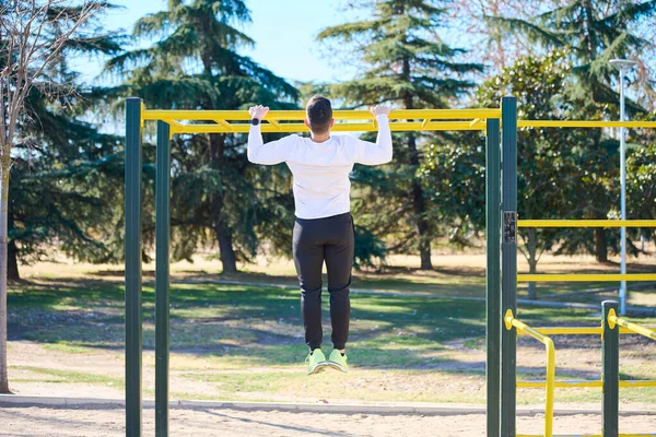 Parkta egzersiz yapan genç çocuk.