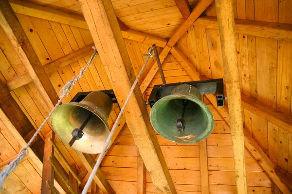 Tow brass bells under wooden roof — Stock Photo, Image