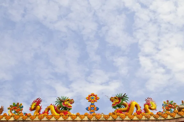 两座金碧辉煌的亚洲龙雕像矗立在一座寺庙的屋顶上 — 图库照片