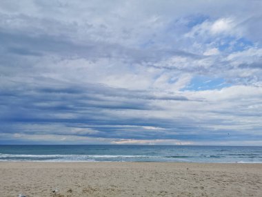 Calm and serene quiet sandy beach in the tranquil afternoon near the sea