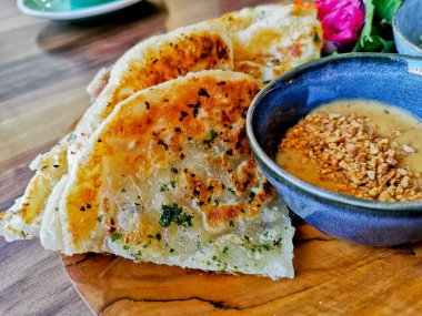 Indian flatbread garlic roti naan with Satay peanut dipping curry sauce