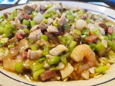 Homemade authenthic mixed Hokkien Chinese fried rice with BBQ pork and prawn pieces with sticky salty sauce and chilli in oil dipping