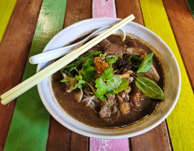 Thai-style blood soup flat rice noodle with beef organs and topping coriander