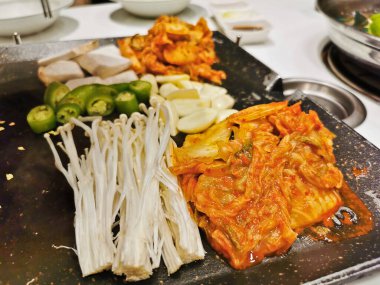 Korean Kimchi fermented cabbage with Enokitake mushroom for Korean BBQ grilled cooking pot