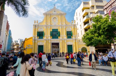 MACAU-MARCH 26 : Tourists visit the Historic Centre of Macao-Senado Square on March 6, 2014 in Macau, China. The Historic Centre of Macao was inscribed on the UNESCO World Heritage List in 2005. clipart