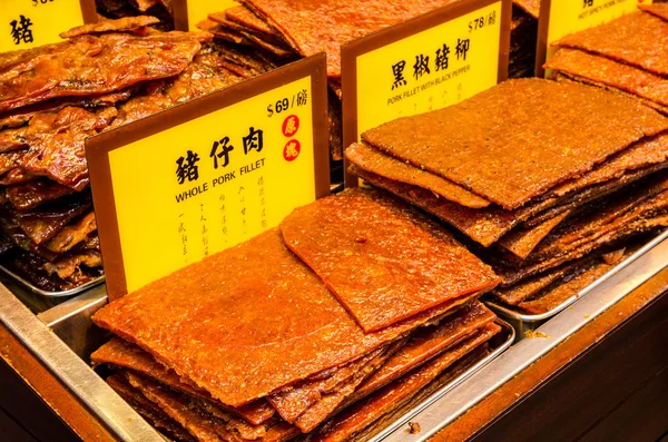 Assortment of Chinese preserved meat selling by the sidewalk of Macau, China. (No trademark or copyrighted material on the price tags). — Stock Photo, Image