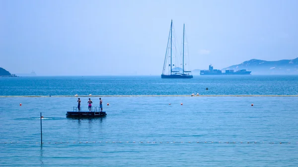 Blue sea with sailboat sailing the ocean surface summer vacation — Stock Photo, Image