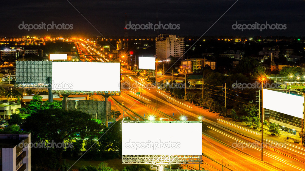 Top view of highway at night with white screen billboard