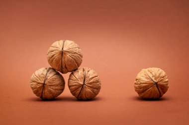 Kahverengi arka planda dört ceviz geometrik olarak bir sağlık ve enerji kavramı olarak 